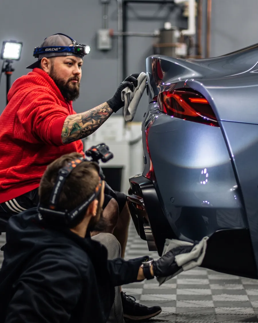 AZ Auto Aesthetics technicians applying XPEL paint protection film to a sports car in the Mesa shop