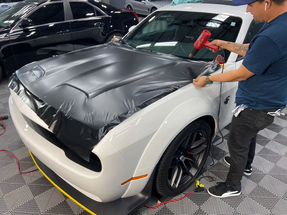 XPEL Stealth satin-black paint protection film applied to a Dodge Challenger hood