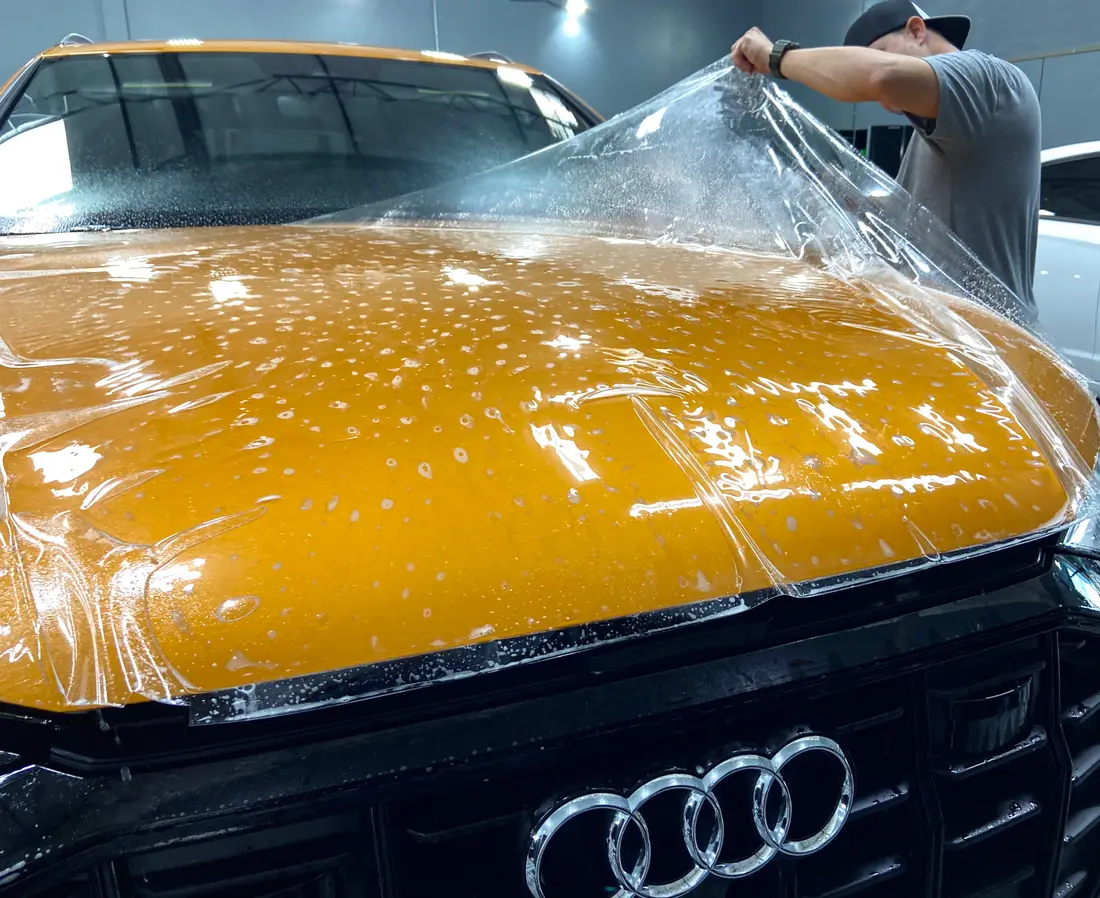 XPEL Ultimate Plus clear paint protection film being installed on an Audi